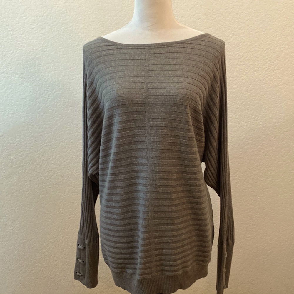 A light sweater top pull over brand name is Soho, New York company